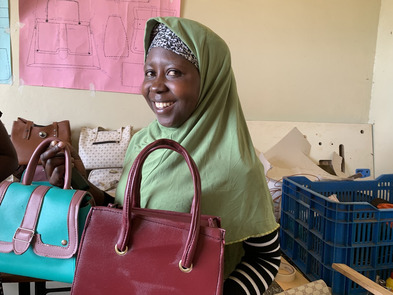 Kangume Margaret im Schulungszentrum der Organisation Mukonomura mit selbstgenähten Handtaschen.